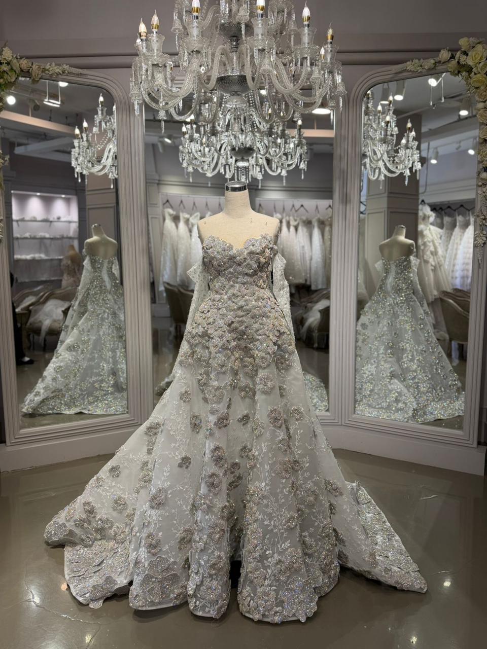 Full-length silver floral bridal gown on a mannequin